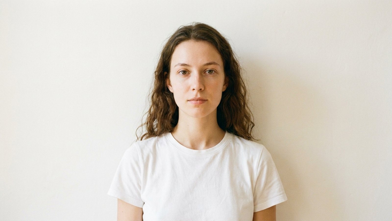 A first casting digital shot against a plain wall with no makeup